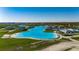 Breathtaking aerial view of the crystal blue lagoon, offering a pristine beach experience and luxurious living in a vibrant community at 9748 Ibis Grove Blvd, Wesley Chapel, FL 33545