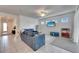 The bright living room features tile floors, a ceiling fan, and lots of natural light at 9748 Ibis Grove Blvd, Wesley Chapel, FL 33545