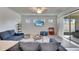 Open-concept living room featuring a ceiling fan, and sliding glass doors leading to the lanai at 9748 Ibis Grove Blvd, Wesley Chapel, FL 33545