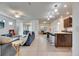 Open-concept living room seamlessly connects with modern kitchen featuring stylish decor and ample natural light at 9748 Ibis Grove Blvd, Wesley Chapel, FL 33545