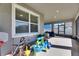 Enclosed patio with outdoor furniture and play area, creating a versatile and enjoyable space at 9748 Ibis Grove Blvd, Wesley Chapel, FL 33545