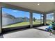 Screened-in patio with an excellent view of the green backyard and blue sky at 9748 Ibis Grove Blvd, Wesley Chapel, FL 33545
