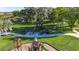 Overhead view of a playground amidst a lush park with mature trees and walking trails at 9748 Ibis Grove Blvd, Wesley Chapel, FL 33545