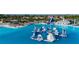 Expansive lagoon featuring floating obstacle course, water slide and other water park attractions at 9748 Ibis Grove Blvd, Wesley Chapel, FL 33545