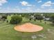Aerial view of a baseball field in a green recreational area, with trees and neighborhood in the background at 10306 Green Grove Pl, Tampa, FL 33624