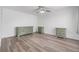 Spacious bedroom features wood-look floors and decorative dressers at 10306 Green Grove Pl, Tampa, FL 33624