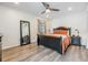 Cozy bedroom features hardwood floors, ceiling fan, and neutral paint scheme at 10306 Green Grove Pl, Tampa, FL 33624