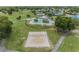 Aerial of a volleyball court, pool and clubhouse in a green residential community at 10306 Green Grove Pl, Tampa, FL 33624