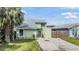 Charming two-story home with mature landscaping, fenced yard, and welcoming front entrance at 10306 Green Grove Pl, Tampa, FL 33624