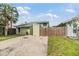 Charming home featuring a well-kept lawn, complemented by mature trees and a private driveway at 10306 Green Grove Pl, Tampa, FL 33624