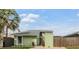 Charming green two-story home featuring a well-maintained front yard with lush landscaping, enhancing its curb appeal at 10306 Green Grove Pl, Tampa, FL 33624