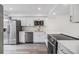 Modern kitchen featuring stainless steel appliances and white countertops with plenty of natural light at 10306 Green Grove Pl, Tampa, FL 33624