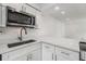 Close up of kitchen area with stainless steel appliances and marble countertops at 10306 Green Grove Pl, Tampa, FL 33624