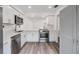 Modern kitchen featuring white cabinets, stainless steel appliances, and stylish countertops at 10306 Green Grove Pl, Tampa, FL 33624