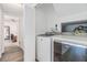 Convenient laundry room with modern washer and dryer units, ensuring efficient and easy chore management at 10306 Green Grove Pl, Tampa, FL 33624