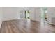 Bright living room with hardwood floors and plenty of natural light with sliding glass door to the outside at 10306 Green Grove Pl, Tampa, FL 33624