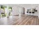 Living room featuring modern floors, sliding glass door access to backyard, and a bar with seating for entertaining at 10306 Green Grove Pl, Tampa, FL 33624
