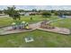 Aerial shot of community playground features a boat-themed play structure and slides amid green spaces at 10306 Green Grove Pl, Tampa, FL 33624