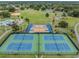 Aerial view featuring tennis and basketball courts, perfect for active community living, surrounded by greenery at 10306 Green Grove Pl, Tampa, FL 33624