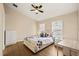 Bright bedroom with a ceiling fan, wood-look flooring, a dresser, and large windows at 11047 Black Swan Ct, Seffner, FL 33584