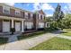 Charming townhome featuring red shutters, well-kept landscaping, and a cozy front porch area at 11047 Black Swan Ct, Seffner, FL 33584