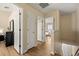 Upstairs hallway featuring wood-look floors and access to bedrooms with natural light at 11047 Black Swan Ct, Seffner, FL 33584