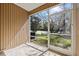 Enclosed back porch with a view of the lush backyard and pond at 11047 Black Swan Ct, Seffner, FL 33584