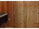 Close-up of a sauna with wooden walls, a heater, and a cozy, relaxing atmosphere at 11725 Derbyshire Dr, Tampa, FL 33626