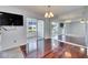 Open dining room with a large mirror wall adjacent to the porch and hardwood flooring at 119 Glendower Cir # 269, Sun City Center, FL 33573