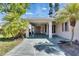 Welcoming home entrance features a patterned driveway, covered parking, and elegant columns at 119 Glendower Cir # 269, Sun City Center, FL 33573