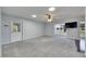 Bright living room with neutral carpet, skylight, and a door with decorative window panel at 119 Glendower Cir # 269, Sun City Center, FL 33573