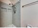 Updated shower with gray tile and built in shower caddy with a handheld shower at 119 Glendower Cir # 269, Sun City Center, FL 33573