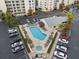 Aerial view of community pool with ample lounge seating and lush landscaping at 1200 Country Club Drive Dr # 3303, Largo, FL 33771