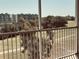 Balcony view overlooking lush greenery, a golf course, and a building in the background at 1200 Country Club Drive Dr # 3303, Largo, FL 33771