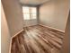 Bedroom featuring wood floors and a window at 1200 Country Club Drive Dr # 3303, Largo, FL 33771