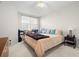 Cozy bedroom with a neutral color scheme and a large window for natural light at 1200 Country Club Drive Dr # 3303, Largo, FL 33771