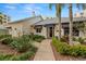 Exterior view with well-manicured landscaping, an inviting walkway at 1200 Country Club Drive Dr # 3303, Largo, FL 33771