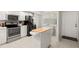 Clean kitchen featuring stainless steel appliances, butcher block island, and white cabinets at 1200 Country Club Drive Dr # 3303, Largo, FL 33771