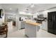 Well-lit kitchen featuring white cabinetry, stainless steel appliances, and a convenient kitchen island at 1200 Country Club Drive Dr # 3303, Largo, FL 33771