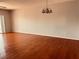 Bright living room with hardwood floors, chandelier, neutral walls, and sliding doors at 1200 Country Club Drive Dr # 3303, Largo, FL 33771