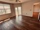 Bright living room featuring wood floors, a ceiling fan, and sliding glass doors to a balcony at 1200 Country Club Drive Dr # 3303, Largo, FL 33771