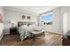 Cozy primary bedroom with hardwood floors, a window view, and a comfortable king-sized bed at 1200 Country Club Drive Dr # 3303, Largo, FL 33771