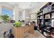 Inviting home office with a large desk, a bookshelf and natural light at 1200 Country Club Drive Dr # 3303, Largo, FL 33771