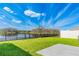 Picturesque backyard with lush green lawn and a black fence overlooking a serene lake at 16051 Weathered Windmill Ter, Odessa, FL 33556