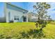 An expansive backyard with lush green grass, partial shade, and black metal fence at 16051 Weathered Windmill Ter, Odessa, FL 33556