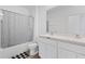 A clean bathroom featuring double sinks, a shower, and a tub at 16051 Weathered Windmill Ter, Odessa, FL 33556