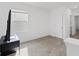 A minimalist bedroom with a neutral carpet and a large window for natural light at 16051 Weathered Windmill Ter, Odessa, FL 33556