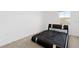 Bedroom with a black platform bed, carpeting, and a large window at 16051 Weathered Windmill Ter, Odessa, FL 33556
