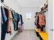 Walk-in closet with ample storage space, featuring shelving, hanging rods, and a small window at 16051 Weathered Windmill Ter, Odessa, FL 33556