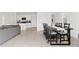 A view of the dining room showcasing a long table and chairs with the kitchen in the background at 16051 Weathered Windmill Ter, Odessa, FL 33556